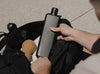 Black stainless steel memobottle in slim being put into a black bag