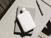 Stainless steel A6 memobottle in white on a grey notebook